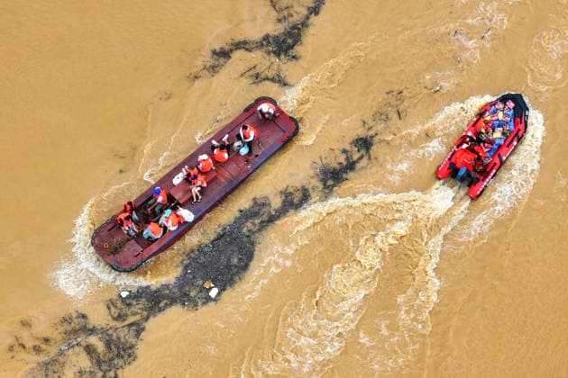 (260709) -- NANNING, July 9, 2026 -- An aerial drone photo shows rescuers evacuating trapped students while sending supplies to schools in Guigang City, south China s Guangxi Zhuang Autonomous Region, July 8, 2026. Recent extreme rainstorms triggered by Typhoon Maysak, the 10th typhoon of the year, have caused severe flooding in parts of Guangxi in the Pearl River basin. Guangxi is continuing its search and rescue operations for missing persons, enhancing resettlement services for affected residents and advancing post-disaster reconstruction. ) FOCUS Guangxi makes all-out rescue, relief efforts after rain-triggered disasters ZhouxHua 