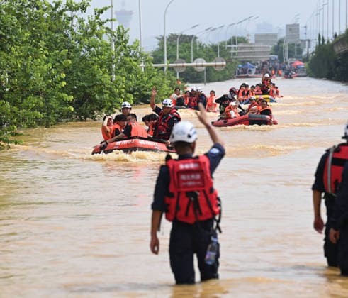 (260709) -- NANNING, July 9, 2026 -- Rescuers evacuate trapped students in Guigang City, south China s Guangxi Zhuang Autonomous Region, July 9, 2026. Recent extreme rainstorms triggered by Typhoon Maysak, the 10th typhoon of the year, have caused severe flooding in parts of Guangxi in the Pearl River basin. Guangxi is continuing its search and rescue operations for missing persons, enhancing resettlement services for affected residents and advancing post-disaster reconstruction. ) FOCUS Guangxi makes all-out rescue, relief efforts after rain-triggered disasters CaoxYiming 