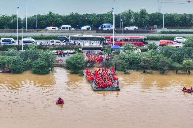 (260709) -- NANNING, July 9, 2026 -- A drone photo shows rescuers evacuating trapped students in Guigang City, south China s Guangxi Zhuang Autonomous Region, July 9, 2026. Recent extreme rainstorms triggered by Typhoon Maysak, the 10th typhoon of the year, have caused severe flooding in parts of Guangxi in the Pearl River basin. Guangxi is continuing its search and rescue operations for missing persons, enhancing resettlement services for affected residents and advancing post-disaster reconstruction. ) FOCUS Guangxi makes all-out rescue, relief efforts after rain-triggered disasters CaoxYiming 