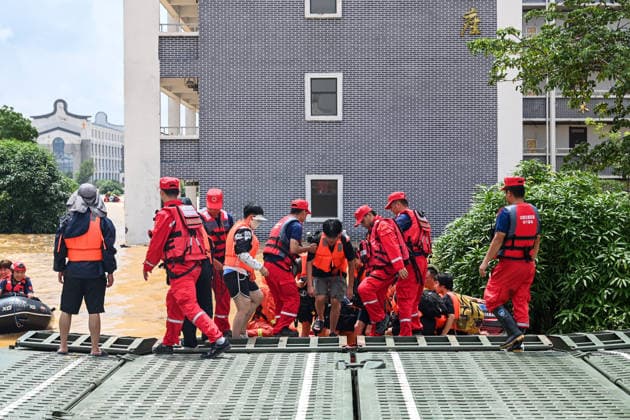 (260709) -- NANNING, July 9, 2026 -- Rescuers evacuate trapped students in Guigang City, south China s Guangxi Zhuang Autonomous Region, July 9, 2026. Recent extreme rainstorms triggered by Typhoon Maysak, the 10th typhoon of the year, have caused severe flooding in parts of Guangxi in the Pearl River basin. Guangxi is continuing its search and rescue operations for missing persons, enhancing resettlement services for affected residents and advancing post-disaster reconstruction. ) FOCUS Guangxi makes all-out rescue, relief efforts after rain-triggered disasters CaoxYiming 