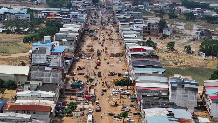 (260709) -- NANNING, July 9, 2026 -- A drone photo shows people removing silt and debris from a street after floodwater recedes in Yunbiao Town of Hengzhou City, south China s Guangxi Zhuang Autonomous Region, July 9, 2026. Recent extreme rainstorms triggered by Typhoon Maysak, the 10th typhoon of the year, have caused severe flooding in parts of Guangxi in the Pearl River basin. Guangxi is continuing its search and rescue operations for missing persons, enhancing resettlement services for affected residents and advancing post-disaster reconstruction. ) FOCUS Guangxi makes all-out rescue, relief efforts after rain-triggered disasters HuangxXiaobang 