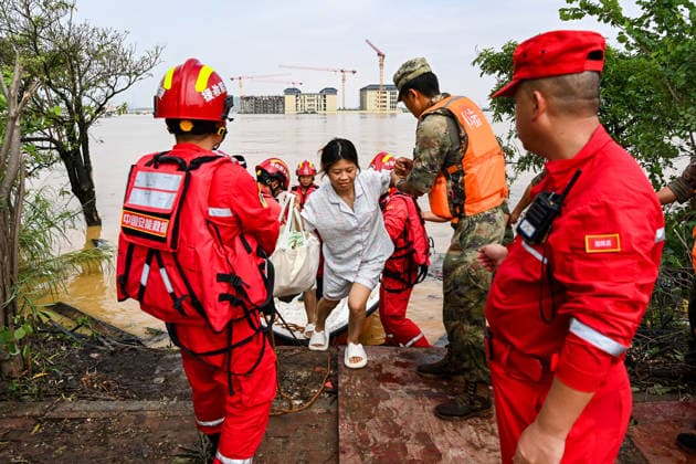 (260709) -- NANNING, July 9, 2026 -- Rescuers evacuate trapped students in Guigang City, south China s Guangxi Zhuang Autonomous Region, July 9, 2026. Recent extreme rainstorms triggered by Typhoon Maysak, the 10th typhoon of the year, have caused severe flooding in parts of Guangxi in the Pearl River basin. Guangxi is continuing its search and rescue operations for missing persons, enhancing resettlement services for affected residents and advancing post-disaster reconstruction. ) FOCUS Guangxi makes all-out rescue, relief efforts after rain-triggered disasters CaoxYiming 