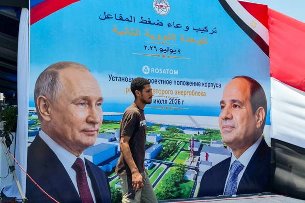 EGYPT, EL DABAA - JULY 9, 2026: A man walks past a banner showing Russia s President Vladimir Putin and Egypt s President Abdel Fattah el-Sisi during a ceremony marking the installation of the reactor pressure vessel for the Second Unit of the El Dabaa Nuclear Power Plant El Dabaa Egypt  - ZUMAt113 20260709_zaa_t113_359 Copyright: xAnastasiaxOlyanderx
