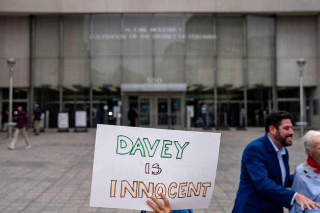 People demonstrate outside the Moultrie Courthouse before the arraignment of Olympic canoeist David Hearn in Washington, DC on Thursday, June 9, 2026. Hearn was indicted on July 2 on one count of destruction of property of more than $1,000 for allegedly damaging the Lincoln Memorial Reflecting Pool, carrying a maximum pentyl of 10 years in prison if convicted.  WAP20260709301 BONNIExCASH