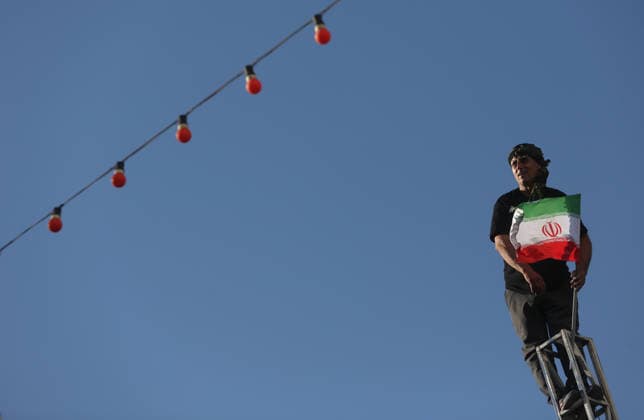 Farewell ceremony held for the late Iranian leader Khamenei in the Iranian city of Mashhad MASHHAD, IRAN - JULY 9: (RESTRICTIONS: No Access Israel Media Persian Language TV Stations Outside Iran Strictly No Access BBC Persian VOA Persian Manoto TV Iran International TV) A man carrying an Iranian flag is seen at the top of an electricity pole as thousands of people, holding flags and posters, gather to participate in the funeral ceremony for the late Iranian Supreme Leader Ali Khamenei, who was killed in a joint U.S.-Israeli airstrike, in Mashhad, Iran on July 9, 2026 Hassan Ghaedi Anadolu Mashhad Iran. Editorial use only. Please get in touch for any other usage.  Copyright: x2026xAnadoluxHassanxGhaedix