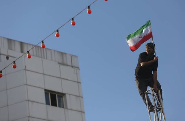 Farewell ceremony held for the late Iranian leader Khamenei in the Iranian city of Mashhad MASHHAD, IRAN - JULY 9: (RESTRICTIONS: No Access Israel Media Persian Language TV Stations Outside Iran Strictly No Access BBC Persian VOA Persian Manoto TV Iran International TV) A man carrying an Iranian flag is seen at the top of an electricity pole as thousands of people, holding flags and posters, gather to participate in the funeral ceremony for the late Iranian Supreme Leader Ali Khamenei, who was killed in a joint U.S.-Israeli airstrike, in Mashhad, Iran on July 9, 2026 Hassan Ghaedi Anadolu Mashhad Iran. Editorial use only. Please get in touch for any other usage.  Copyright: x2026xAnadoluxHassanxGhaedix