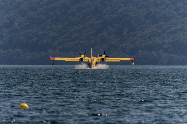 Wildfires rage for 10th day in northern Italy ORTA, ITALY - JULY 9: A firefighting Canadair aircraft scoops up a load of water from Lake Orta to combat a wildfire devastating the mountains of Piedmont, Italy, Thursday, July 9, 2026. The blaze has been raging for ten days, with hundreds of hectares of land going up in smoke in the last 24 hours alone. Despite continuous aerial operations, the fire remains out of control, fueled by strong winds, prolonged lack of rainfall, and recent extremely high temperatures. Andrea Carrubba Anadolu Piedmont Italy. Editorial use only. Please get in touch for any other usage.  Copyright: x2026xAnadoluxAndreaxCarrubbax