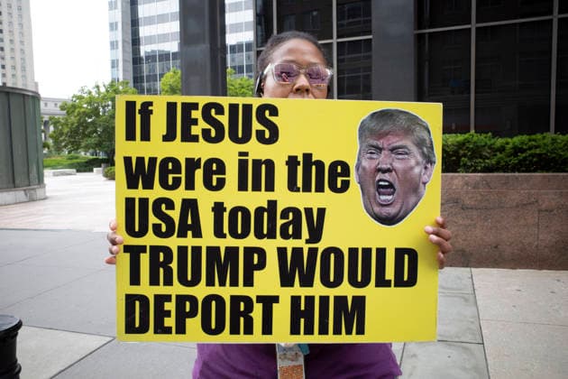 July 9, 2026, New York, New York, USA: A protester holds a sign that reads If Jesus were in the USA today TRUMP WOULD DEPORT HIM with an image of President Trump at Rise and Resist s weekly vigil for those impacted by President Trump s immigrant detention and mass deportation policies, held outside the immigration courts, Department of Homeland Security and ICE offices at 26 Federal Plaza in Lower Manhattan. The demonstration takes place days after the death of L. Salgado Araujo who was shot and killed by U.S. Immigration and Customs Enforcement (ICE) in Houston during a targeted enforcement operation. New York USA  - ZUMAr174 20260709_znp_r174_015 Copyright: xGinaxMxRandazzox