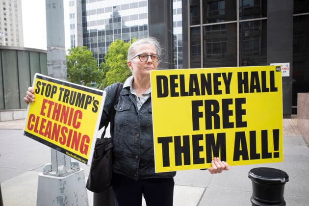 July 9, 2026, New York, New York, USA: A protester holds signs that read STOP TRUMP s ETHNIC CLEANSING DELANEY HALL FREE THEM ALL! at Rise and Resist s weekly vigil for those impacted by President Trump s immigrant detention and mass deportation policies, held outside the immigration courts, Department of Homeland Security and ICE offices at 26 Federal Plaza in Lower Manhattan. The demonstration takes place days after the death of L. Salgado Araujo who was shot and killed by U.S. Immigration and Customs Enforcement (ICE) in Houston during a targeted enforcement operation. New York USA  - ZUMAr174 20260709_znp_r174_016 Copyright: xGinaxMxRandazzox