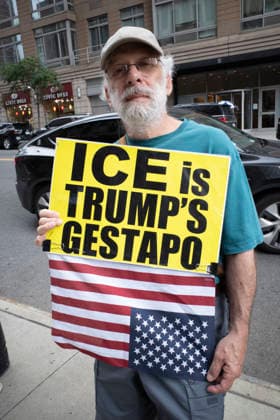 July 9, 2026, New York, New York, USA: A protester holds a sign that reads ICE is TRUMP S GESTAPO and an upside down American flag at Rise and Resist s weekly vigil for those impacted by President Trump s immigrant detention and mass deportation policies, held outside the immigration courts, Department of Homeland Security and ICE offices at 26 Federal Plaza in Lower Manhattan. The demonstration takes place days after the death of L. Salgado Araujo who was shot and killed by U.S. Immigration and Customs Enforcement (ICE) in Houston during a targeted enforcement operation. New York USA  - ZUMAr174 20260709_znp_r174_017 Copyright: xGinaxMxRandazzox