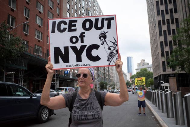 July 9, 2026, New York, New York, USA: A protester holds a sign that reads ICE OUT OF NYC with an image of the Statue of Liberty and wears a shirt that reads I DRINK MY HORCHATA WARM CAUSE FUCK ICE at Rise and Resist s weekly vigil for those impacted by President Trump s immigrant detention and mass deportation policies, held outside the immigration courts, Department of Homeland Security and ICE offices at 26 Federal Plaza in Lower Manhattan. The demonstration takes place days after the death of L. Salgado Araujo who was shot and killed by U.S. Immigration and Customs Enforcement (ICE) in Houston during a targeted enforcement operation. New York USA  - ZUMAr174 20260709_znp_r174_018 Copyright: xGinaxMxRandazzox