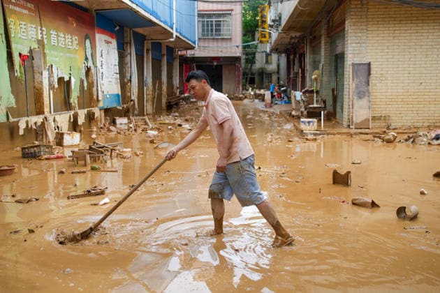 GUIGANG, CHINA - JULY 09: A resident clears silt and debris after floodwater recedes on July 9, 2026 in Guigang, Guangxi Zhuang Autonomous Region of China. Recent extreme rainstorms triggered by Typhoon Maysak, the 10th typhoon of the year, have caused severe flooding in parts of Guangxi in the Pearl River basin. Guangxi is continuing its search and rescue operations for missing persons, enhancing resettlement services for affected residents and advancing post-disaster reconstruction.  Copyright: xChinaxNewsxServicex 111653326830