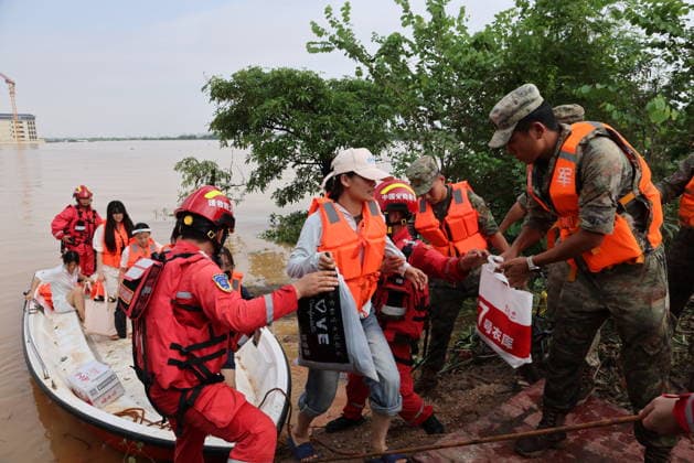GUIGANG, CHINA - JULY 09: Rescuers evacuate trapped students on July 9, 2026 in Guigang, Guangxi Zhuang Autonomous Region of China. Recent extreme rainstorms triggered by Typhoon Maysak, the 10th typhoon of the year, have caused severe flooding in parts of Guangxi in the Pearl River basin. Guangxi is continuing its search and rescue operations for missing persons, enhancing resettlement services for affected residents and advancing post-disaster reconstruction.  Copyright: xVCGx 111653352912