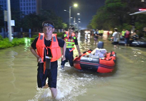 (260710) -- GUIGANG, July 10, 2026 -- Rescuers wade through floodwater to deliver supplies to stranded residents in Guigang, south China s Guangxi Zhuang Autonomous Region, July 9, 2026. Guigang has suffered severe flooding due to torrential rains brought by Typhoon Maysak and upstream inflows. Local authorities have mobilized rescue forces to work around the clock, making every effort to ensure basic living needs for stranded residents. ) CHINA-GUANGXI-GUIGANG-TYPHOON-FLOOD-RESCUE (CN) ZhouxHua 