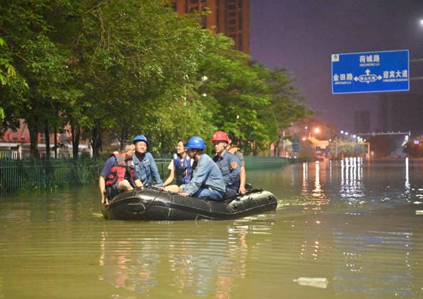 (260710) -- GUIGANG, July 10, 2026 -- Rescuers take a boat through floodwater in Guigang, south China s Guangxi Zhuang Autonomous Region, July 9, 2026. Guigang has suffered severe flooding due to torrential rains brought by Typhoon Maysak and upstream inflows. Local authorities have mobilized rescue forces to work around the clock, making every effort to ensure basic living needs for stranded residents. ) CHINA-GUANGXI-GUIGANG-TYPHOON-FLOOD-RESCUE (CN) ZhouxHua 