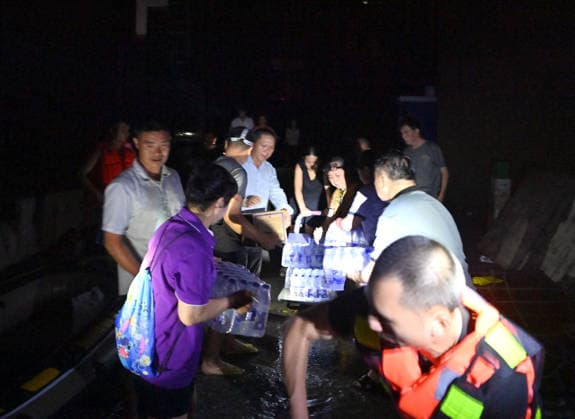 (260710) -- GUIGANG, July 10, 2026 -- Rescuers deliver supplies to stranded residents in Guigang, south China s Guangxi Zhuang Autonomous Region, July 9, 2026. Guigang has suffered severe flooding due to torrential rains brought by Typhoon Maysak and upstream inflows. Local authorities have mobilized rescue forces to work around the clock, making every effort to ensure basic living needs for stranded residents. ) CHINA-GUANGXI-GUIGANG-TYPHOON-FLOOD-RESCUE (CN) ZhouxHua 