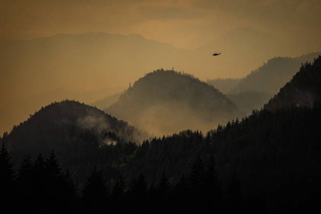 July 9, 2026, Boston Bar, Bc, CANADA: A helicopter being used to fight the Brunswick Creek wildfire prepares to pick up more water as smoke from the Ainslie Creek wildfire is seen in the distance, in Boston Bar, B.C., on Thursday, July 9, 2026. Boston Bar CANADA  - ZUMAc35_ 20260709_zaf_c35_093 Copyright: xDarrylxDyckx