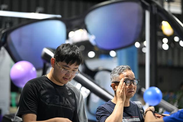 2026 AI Terminal Industry Expo NANJING, CHINA - JULY 10, 2026 - Visitors experience smart glasses at the Qwen AI Glasses booth at the 2026 Artificial Intelligence Terminal Industry Expo in Nanjing, Jiangsu Province, China on July 10, 2026. Nanjing Jiangsu China  Copyright: xCFOTOx i1783688703728