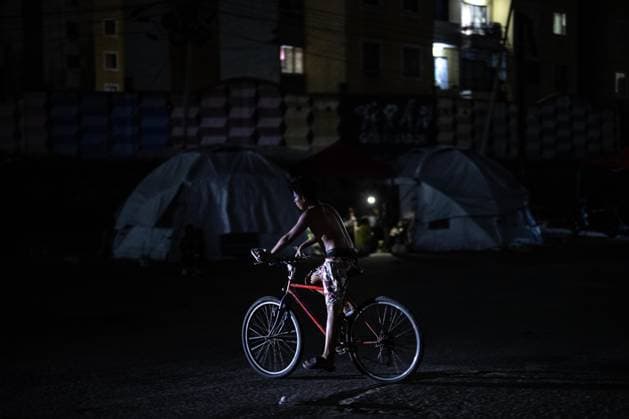 Earthquake survivors continue living in temporary shelters in La Guaira LA GUAIRA, VENEZUELA - JULY 10: A boy rides a bicycle near temporary shelters in La Guaira, Venezuela, on July 10, 2026. Residents continue to stay in tents after the powerful 7.2 and 7.5 magnitude earthquakes that struck Venezuela in succession on June 24 caused widespread destruction in the coastal city, forcing thousands of people to leave their homes. Cem Tekkesinoglu Anadolu La Guaira Venezuela. Editorial use only. Please get in touch for any other usage.  Copyright: x2026xAnadoluxCemxTekkesinoglux