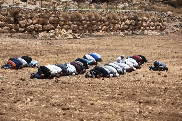 Israeli settlers prevented Palestinian farmers from accessing their agricultural lands in Hebron HEBRON, WEST BANK, PALESTINE - JULY 10: Palestinians perform Friday prayers on land threatened with confiscation by Israel while Israeli settlers, protected by Israeli forces, continue to block roads leading to Palestinian farmers lands in the town of Izna, near Hebron, West Bank, Palestine on July 10, 2026. Wisam Hashlamoun Anadolu Hebron West Bank. Editorial use only. Please get in touch for any other usage.  Copyright: x2026xAnadoluxWisamxHashlamounx