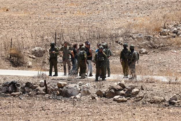 Israeli settlers prevented Palestinian farmers from accessing their agricultural lands in Hebron HEBRON, WEST BANK, PALESTINE - JULY 10: Israeli security forces take measures along the road as Israeli settlers, protected by Israeli forces, block roads leading to Palestinian farmers lands in the town of Izna, near Hebron in the West Bank, Palestine on July 10, 2026. Wisam Hashlamoun Anadolu Hebron West Bank. Editorial use only. Please get in touch for any other usage.  Copyright: x2026xAnadoluxWisamxHashlamounx