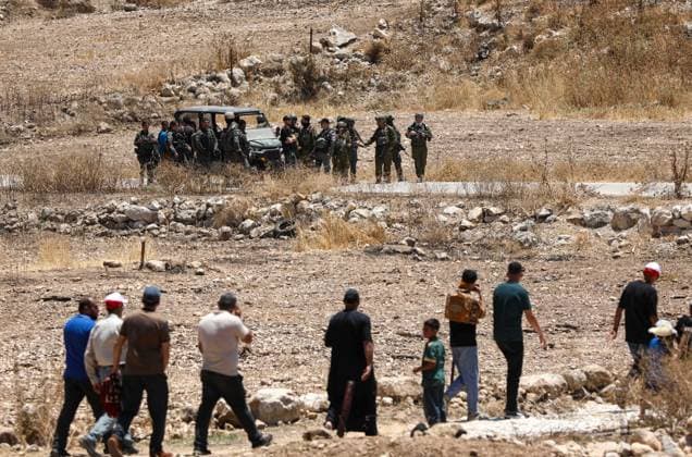 Israeli settlers prevented Palestinian farmers from accessing their agricultural lands in Hebron HEBRON, WEST BANK, PALESTINE - JULY 10: Palestinians are seen after performing Friday prayers on land threatened with confiscation by Israel while Israeli settlers, protected by Israeli forces, continue to block roads leading to Palestinian farmers lands in the town of Izna, near Hebron, West Bank, Palestine on July 10, 2026. Wisam Hashlamoun Anadolu Hebron West Bank. Editorial use only. Please get in touch for any other usage.  Copyright: x2026xAnadoluxWisamxHashlamounx