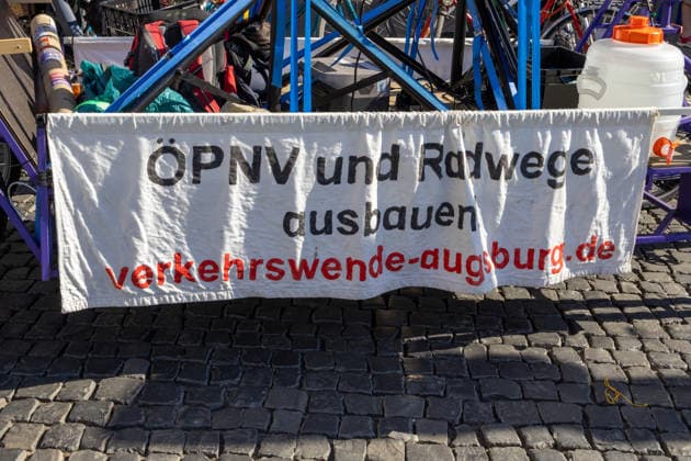 Augsburg, Bavaria, Germany - July 10, 2026: Demonstration by the climate justice movement Fridays for Future and Greenpeace in Augsburg. Under the nationwide slogan: Protect the climate, fire the rich, the activists are protesting, among other things, against current gas infrastructure policy and planned gas drilling in Bavaria. Banner: Expand public transit and bike lanes; transport transition in Augsburg *** Demonstration der Klimaschutzbewegung Fridays for Future und GREENPEACE in Augsburg. Unter dem bundesweiten Motto: Klima schützen, Reiche entlassen, protestieren die Aktivisten unter anderem gegen die aktuelle Gas-Infrastrukturpolitik und geplante Gasbohrungen in Bayern. Banner: ÖPNV und Radwege ausbauen, Verkehrswende Augsb