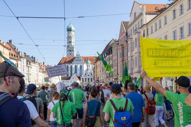 Augsburg, Bavaria, Germany - July 10, 2026: Demonstration by the climate justice movement Fridays for Future and GREENPEACE in Augsburg. Under the nationwide slogan: Protect the climate, fire the rich, the activists are protesting, among other things, against current gas infrastructure policy and planned gas drilling in Bavaria. Demonstrators march through the city carrying FFF flags and GREENPEACE signs: STOP GAS DRILLING IN BAVARIA! *** Demonstration der Klimaschutzbewegung Fridays for Future und GREENPEACE in Augsburg. Unter dem bundesweiten Motto: Klima schützen, Reiche entlassen, protestieren die Aktivisten unter anderem gegen die aktuelle Gas-Infrastrukturpolitik und geplante Gasbohrungen in Bayern. Demonstranten laufen durch