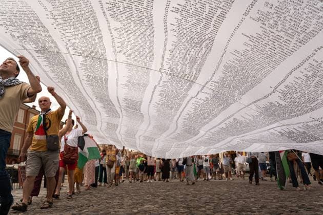 ITALY-GAZA PROTEST CESENA, ITALY, JULY 10, 2026 Participants march beneath a giant white shroud covered with the names of 18,457 Palestinian children killed in Gaza since October 2023 during the Shroud for Gaza demonstration in Cesena, northern Italy. The memorial installation is part of a travelling national initiative that has crossed several Italian cities to honour the victims of the war and draw attention to the humanitarian consequences of the conflict. (Silvia Casadei JNA Press) Cesena Italy Copyright: x xSilviaxCasadeix xJNAxPressx