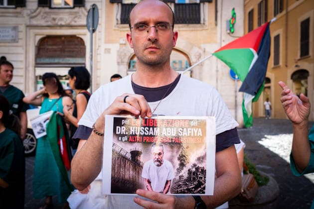 July 10, 2026, Rome, Rm, Italy: Activists from the group Health Workers for Gaza are holding a rally in front of Montecitorio, the Chamber of Deputies, to demand the release of Dr. Hussam Abu Safiya and all other Palestinian prisoners. A participant shows the picture of Dr. Abu Safiya. Rome Italy - ZUMAg256 20260710_znp_g256_011 Copyright: xMarcoxDixGianvitox