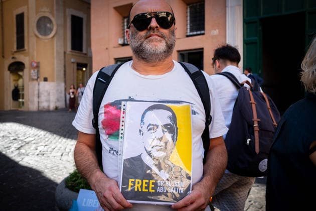 July 10, 2026, Rome, Rm, Italy: Activists from the group Health Workers for Gaza are holding a rally in front of Montecitorio, the Chamber of Deputies, to demand the release of Dr. Hussam Abu Safiya and all other Palestinian prisoners. A participant shows the picture of Dr. Abu Safiya. Rome Italy - ZUMAg256 20260710_znp_g256_015 Copyright: xMarcoxDixGianvitox