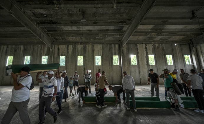 Coffins brought to Musalla in Potocari: The last farewell to the victims of the genocide in Srebrenica SREBRENICA, BOSNIA AND HERZEGOVINA - JULY 10: Family members of the victims and Peace March participants carry coffins containing the remains of ten Srebrenica genocide victims from the former Battery Factory to the Musalla area at the Potocari Memorial Center Cemetery in Srebrenica, Bosnia and Herzegovina, on July 10, 2026. Relatives and participants gathered with prayers and tears ahead of tomorrow s collective funeral and burial on the 31st anniversary of the 1995 genocide. Samir Jordamovic Anadolu Srebrenica Bosnia and Herzegovina. Editorial use only. Please get in touch for any other usage.  Copyright: x2026xAnadoluxSamirxJordamovicx