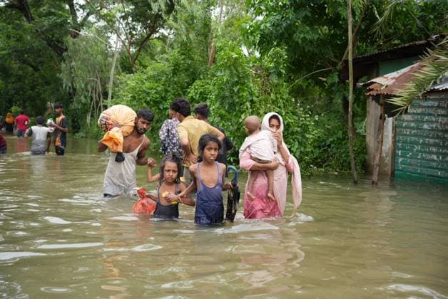 July 10, 2026, Banshkhali, Bangladesh: BANSHKHALI, CHATTOGRAM, BANGLADESH Ã¢â‚¬ JULY 10, 2026: Residents wade through floodwaters and evacuate children and belongings after days of heavy monsoon rainfall, runoff from surrounding hills and high tides caused severe flooding in Banshkhali Upazila, Chattogram. Hundreds of homes, roads and agricultural land have been inundated, leaving many families stranded and increasing concerns over access to shelter, clean water and essential services. Authorities and local volunteers continue to monitor the situation as affected residents wait for floodwaters to recede. Photos by JNA PRESS. Banshkhali Bangladesh  - ZUMAq101 20260710_zna_q101_061 Copyright: xIstiyakxAhamedxSrabonx
