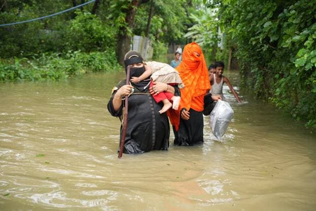 July 10, 2026, Banshkhali, Bangladesh: BANSHKHALI, CHATTOGRAM, BANGLADESH Ã¢â‚¬ JULY 10, 2026: Residents wade through floodwaters and evacuate children and belongings after days of heavy monsoon rainfall, runoff from surrounding hills and high tides caused severe flooding in Banshkhali Upazila, Chattogram. Hundreds of homes, roads and agricultural land have been inundated, leaving many families stranded and increasing concerns over access to shelter, clean water and essential services. Authorities and local volunteers continue to monitor the situation as affected residents wait for floodwaters to recede. Photos by JNA PRESS. Banshkhali Bangladesh  - ZUMAq101 20260710_zna_q101_065 Copyright: xIstiyakxAhamedxSrabonx