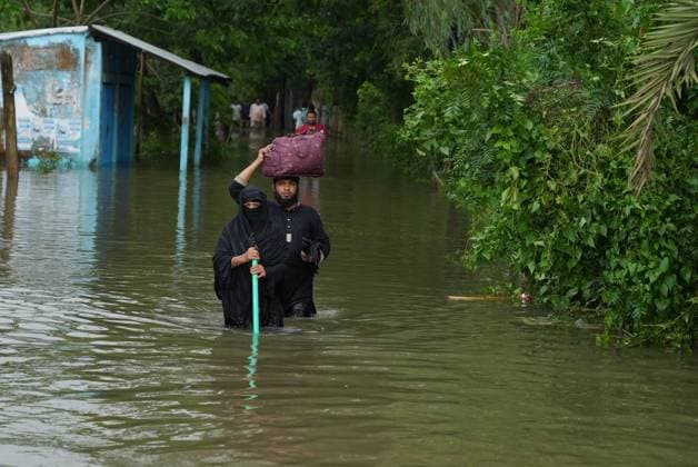 July 10, 2026, Banshkhali, Bangladesh: BANSHKHALI, CHATTOGRAM, BANGLADESH Ã¢â‚¬ JULY 10, 2026: Residents wade through floodwaters and evacuate children and belongings after days of heavy monsoon rainfall, runoff from surrounding hills and high tides caused severe flooding in Banshkhali Upazila, Chattogram. Hundreds of homes, roads and agricultural land have been inundated, leaving many families stranded and increasing concerns over access to shelter, clean water and essential services. Authorities and local volunteers continue to monitor the situation as affected residents wait for floodwaters to recede. Photos by JNA PRESS. Banshkhali Bangladesh  - ZUMAq101 20260710_zna_q101_069 Copyright: xIstiyakxAhamedxSrabonx