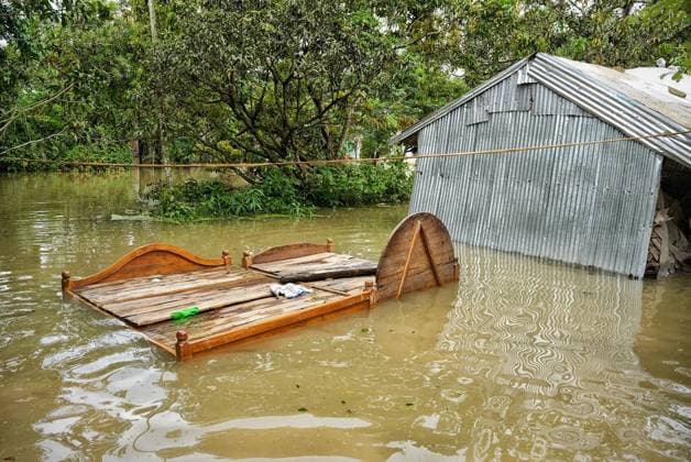 July 10, 2026, Banshkhali, Bangladesh: BANSHKHALI, CHATTOGRAM, BANGLADESH Ã¢â‚¬ JULY 10, 2026: Residents wade through floodwaters and evacuate children and belongings after days of heavy monsoon rainfall, runoff from surrounding hills and high tides caused severe flooding in Banshkhali Upazila, Chattogram. Hundreds of homes, roads and agricultural land have been inundated, leaving many families stranded and increasing concerns over access to shelter, clean water and essential services. Authorities and local volunteers continue to monitor the situation as affected residents wait for floodwaters to recede. Photos by JNA PRESS. Banshkhali Bangladesh  - ZUMAq101 20260710_zna_q101_073 Copyright: xIstiyakxAhamedxSrabonx