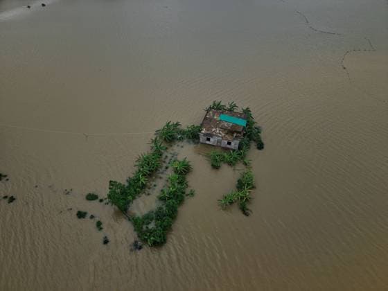 July 10, 2026, Banshkhali, Bangladesh: BANSHKHALI, CHATTOGRAM, BANGLADESH Ã¢â‚¬ JULY 10, 2026: Residents wade through floodwaters and evacuate children and belongings after days of heavy monsoon rainfall, runoff from surrounding hills and high tides caused severe flooding in Banshkhali Upazila, Chattogram. Hundreds of homes, roads and agricultural land have been inundated, leaving many families stranded and increasing concerns over access to shelter, clean water and essential services. Authorities and local volunteers continue to monitor the situation as affected residents wait for floodwaters to recede. Photos by JNA PRESS. Banshkhali Bangladesh  - ZUMAq101 20260710_zna_q101_083 Copyright: xIstiyakxAhamedxSrabonx