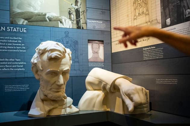 A visitor looks at a bust of former US president Abraham Lincoln is on display in the newly-remodeled undercroft beneath the Lincoln Memorial in Washington, DC on Friday, July 10, 2026. The new 15,000-square-foot exhibit showcases the massive concrete foundations that support the memorial while telling the story of how the Lincoln Memorial was designed and built.  WAP20260710338 BONNIExCASH