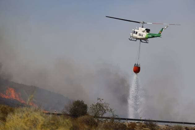 July 10, 2026, Almeria, ES: ALMERIA, SPAIN - JULY 10: An exhausted firefighter rests near an INFOCA emergency vehicle while a colleague holds a bottle of water during a massive wildfire in Los Gallardos, Almeria province, southern Spain, on July 10, 2026. This disaster represents the most severe fire event in the history of Andalusia, resulting in twelve confirmed fatalities, twenty-three individuals missing, and the urgent evacuation of six hundred citizens, with emergency relief teams coordinating temporary housing from the nearby town of Garrucha. Stinger Jna press Almeria ES  - ZUMAq101 20260710_zna_q101_115 Copyright: xEditorx