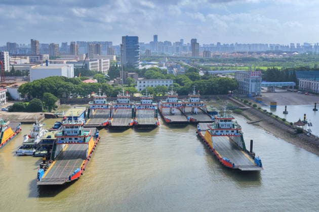 NANTONG, CHINA - JULY 11: Trucks queue waiting to cross the river as the Tongsha ferry service is suspended on July 11, 2026 in Nantong, Jiangsu Province of China. Multiple ferry services along the Jiangsu section of the Yangtze River have been temporarily suspended due to a typhoon.  Copyright: xVCGx 111653635302