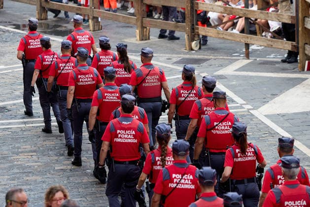 San Fermin Festival in Spain PAMPLONA, SPAIN - JULY 11: Security forces are seen as participants wearing traditional white outfits and red scarves take part in the running with the bulls event, known as Encierro, during the San Fermin Festival in Pamplona, northern Spain, on July 11, 2026. The adrenaline-filled run covers an 875-meter stretch through the historic city center. Ruben Albarran Anadolu Pamplona Spain. Editorial use only. Please get in touch for any other usage.  Copyright: x2026xAnadoluxRubenxAlbarranx