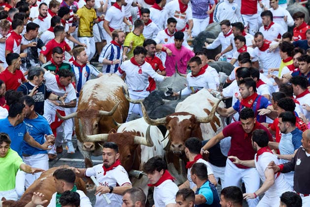 San Fermin Festival in Spain PAMPLONA, SPAIN - JULY 11: Participants wearing traditional white outfits and red scarves take part in the running with the bulls event, known as Encierro, during the San Fermin Festival in Pamplona, northern Spain, on July 11, 2026. The adrenaline-filled run covers an 875-meter stretch through the historic city center. Ruben Albarran Anadolu Pamplona Spain. Editorial use only. Please get in touch for any other usage.  Copyright: x2026xAnadoluxRubenxAlbarranx