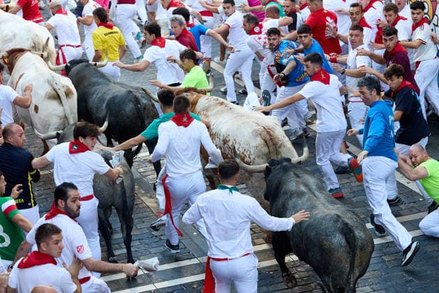 San Fermin Festival in Spain PAMPLONA, SPAIN - JULY 11: Participants wearing traditional white outfits and red scarves take part in the running with the bulls event, known as Encierro, during the San Fermin Festival in Pamplona, northern Spain, on July 11, 2026. The adrenaline-filled run covers an 875-meter stretch through the historic city center. Ruben Albarran Anadolu Pamplona Spain. Editorial use only. Please get in touch for any other usage.  Copyright: x2026xAnadoluxRubenxAlbarranx