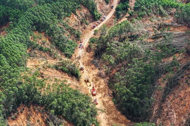 (260711) -- HENGZHOU, July 11, 2026 -- An aerial drone photo taken on July 11, 2026 shows rescuers clearing up a road leading to Zhenlong Township in Hengzhou, south China s Guangxi Zhuang Autonomous Region. One main road leading to the government seat of Zhenlong Township in the city of Hengzhou, south China s Guangxi Zhuang Autonomous Region, was preliminarily opened to traffic at around 1:30 p.m. on Saturday, Xinhua reporters at the rescue site have confirmed. With a permanent population of about 8,000, the township had been trapped as an isolated island. Hit by continuous heavy rainfall, the entire township was cut off from outside access with no open roads, power or network services starting from July 5. The opening of the mai 
