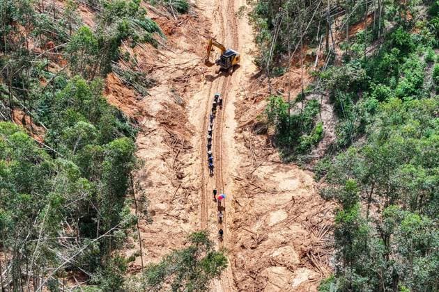 (260711) -- HENGZHOU, July 11, 2026 -- An aerial drone photo taken on July 11, 2026 shows rescuers clearing up a road leading to Zhenlong Township in Hengzhou, south China s Guangxi Zhuang Autonomous Region. One main road leading to the government seat of Zhenlong Township in the city of Hengzhou, south China s Guangxi Zhuang Autonomous Region, was preliminarily opened to traffic at around 1:30 p.m. on Saturday, Xinhua reporters at the rescue site have confirmed. With a permanent population of about 8,000, the township had been trapped as an isolated island. Hit by continuous heavy rainfall, the entire township was cut off from outside access with no open roads, power or network services starting from July 5. The opening of the mai 