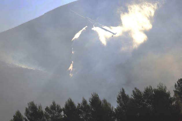 Firefighters battle wildfires in western and southern Sicily SICILY, ITALY - JULY 11: Firefighters work to control wildfires that broke out in maquis areas across the western and southern parts of Sicily, Italy on July 11, 2026. Following initial overnight responses by ground crews with water tenders, helicopters and firefighting aircraft launched aerial operations at sunrise to bring the wind-driven fires under control. Alberto Lo Bianco Anadolu Sicily Italy. Editorial use only. Please get in touch for any other usage.  Copyright: x2026xAnadoluxAlbertoxLoxBiancox