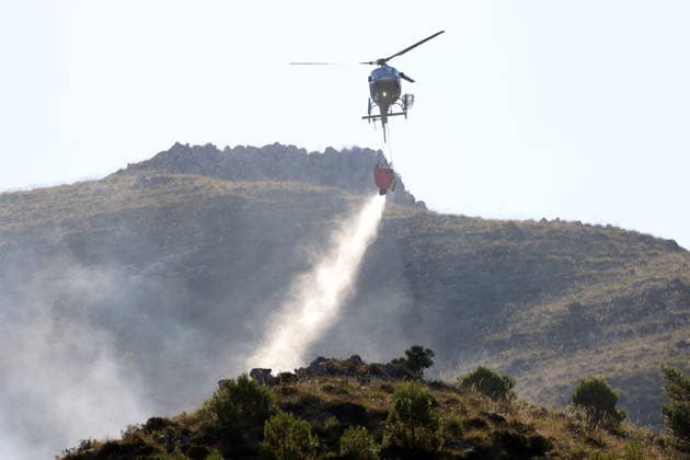 Firefighters battle wildfires in western and southern Sicily SICILY, ITALY - JULY 11: A firefighting helicopter drops water to control wildfires in maquis areas across the western and southern parts of Sicily, Italy on July 11, 2026. Following initial overnight responses by ground crews with water tenders, helicopters and firefighting aircraft launched aerial operations at sunrise to bring the wind-driven fires under control. Alberto Lo Bianco Anadolu Sicily Italy. Editorial use only. Please get in touch for any other usage.  Copyright: x2026xAnadoluxAlbertoxLoxBiancox