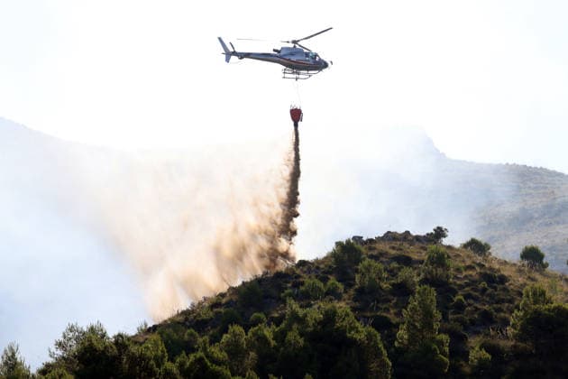 Firefighters battle wildfires in western and southern Sicily SICILY, ITALY - JULY 11: A firefighting helicopter drops water to control wildfires in maquis areas across the western and southern parts of Sicily, Italy on July 11, 2026. Following initial overnight responses by ground crews with water tenders, helicopters and firefighting aircraft launched aerial operations at sunrise to bring the wind-driven fires under control. Alberto Lo Bianco Anadolu Sicily Italy. Editorial use only. Please get in touch for any other usage.  Copyright: x2026xAnadoluxAlbertoxLoxBiancox