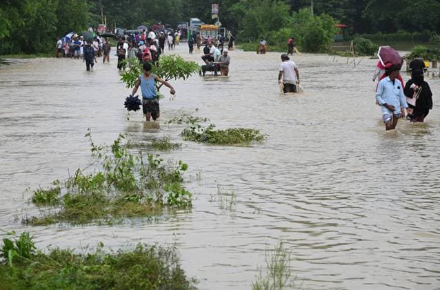July 11, 2026, Satkania, Chattogram, Bangladesh: July 11, 2026, Satkania, Chattogram, Bangladesh: Residents use carts and boats to cross flooded roads as severe floods and landslides hit Chattogram Division. At least 39 people have died and more than 928,000 are affected across five districts. Thousands remain stranded amid shortages of food, safe water and medicines as rescue and relief operations continue. Satkania Bangladesh - ZUMAh178 20260711_zip_h178_026 Copyright: xMuhammadxAmdadxHossainx