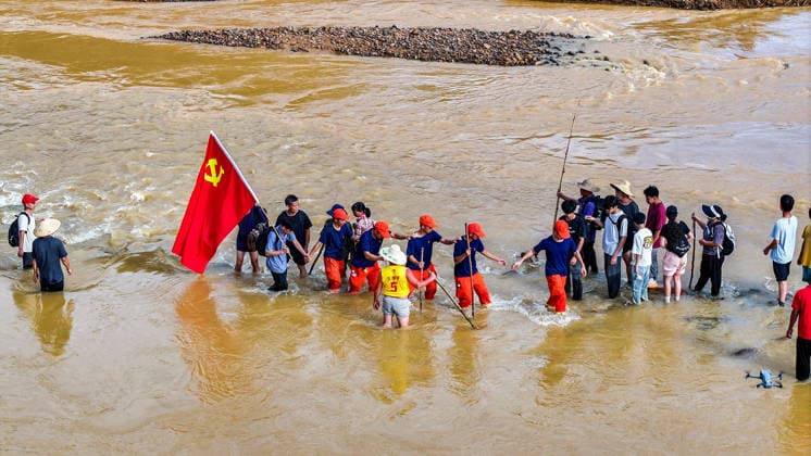 (260711) -- NANNING, July 11, 2026 -- An aerial drone photo shows rescuers heading towards Zhenlong Township of Hengzhou, south China s Guangxi Zhuang Autonomous Region, July 11, 2026. Triggered by Typhoon Maysak, the tenth typhoon of the year, heavy downpours battered multiple areas in south China s Guangxi Zhuang Autonomous Region, resulting in a series of disasters. Various response forces have pooled their efforts, carrying out operations including rescue missions in remote mountainous areas, restoration of transport and power infrastructure, and silt clearing operations. ) CHINA-GUANGXI-TYPHOON-FLOOD-RESCUE (CN) HuangxXiaobang 